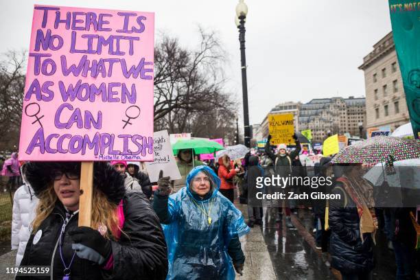 Demonstrators carry signs during the 2020 Women's March on January 18, 2020 in Washington, DC. Marches were held nationwide in cities including New...