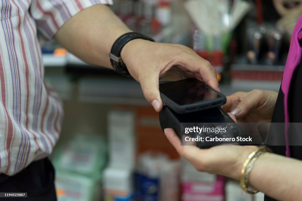 A cashless man paying with smartphone