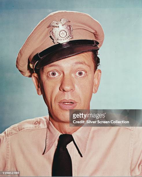 Don Knotts , US actor, in costume in a studio portrait, against a blue background, issued as publicity for the television series. 'The Andy Griffith...