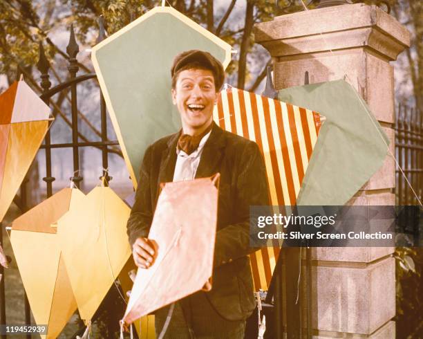 Dick Van Dyke, US actor, poses with a variety of kites in a publicity still for the film, 'Mary Poppins', USA, 1964. The film musical, directed by...