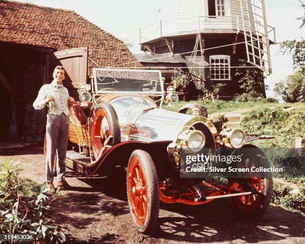 Dick Van Dyke posing beside the car, in a publicity portrait issued for the film, 'Chitty Chitty Bang Bang', United Kingdom, 1968. The 1968 musical,...