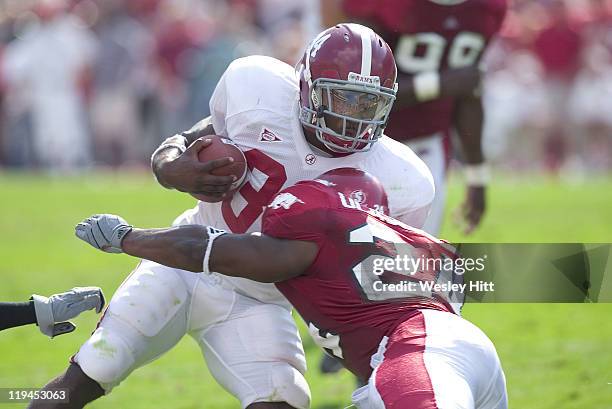 Arkansas Razorback linebacker Sam Olajubutu tackles Alabama Crimson Tide running back Kenneth Darby during a 27 to 10 win by the Razorbacks on...