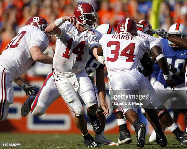 Alabama quarterback John Parker Wilson makes this handoff to Kenneth Darby during Saturday's contest at Ben Hill Griffin Stadium in Gainesville,...