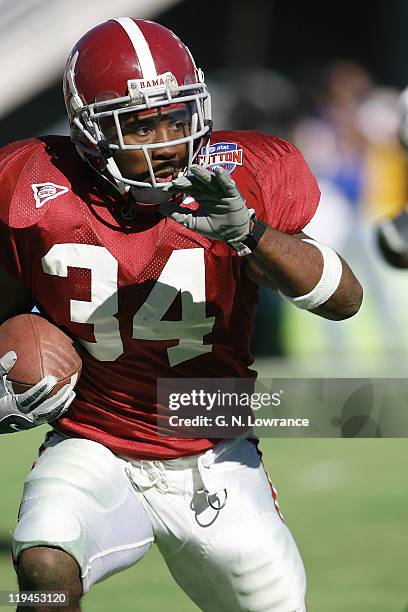 Running back Kenneth Darby of the Alabama Crimson Tide looks for an opening during a 13-10 victory over the Texas Tech Red Raiders at the AT&T Cotton...