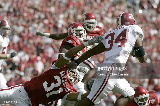 Arkansas linebacker Matt Hewitt tries to drag down Alabama running back Kenneth Darby Saturday September 23, 2006 at Reynolds Razorback stadium in...