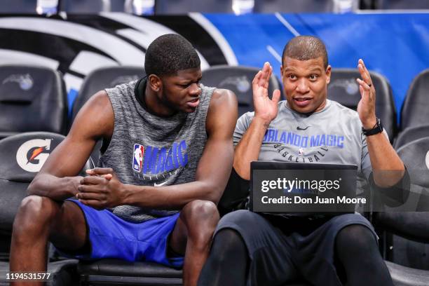 Mo Bamba goes over some game film with Assistant Coach Mike Batiste of the Orlando Magic before the game against the Los Angeles Lakers at the Amway...