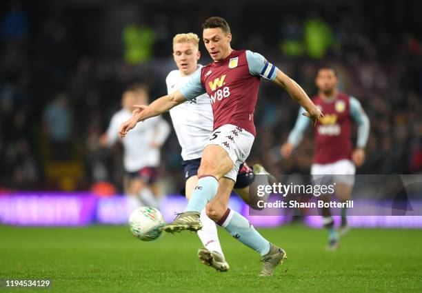 James Chester of Aston Villa controls the ball under pressure from Luis Longstaff of Liverpool during the Carabao Cup Quarter Final match between...