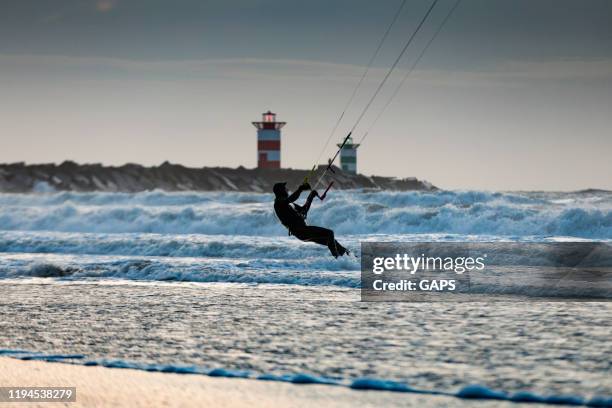 surfer on the waves at the public beach of scheveningen - scheveningen stock pictures, royalty-free photos & images