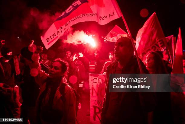 Protestors march through the streets of Paris chanting against President Macron as thousands take to the streets in support of the National Strike on...