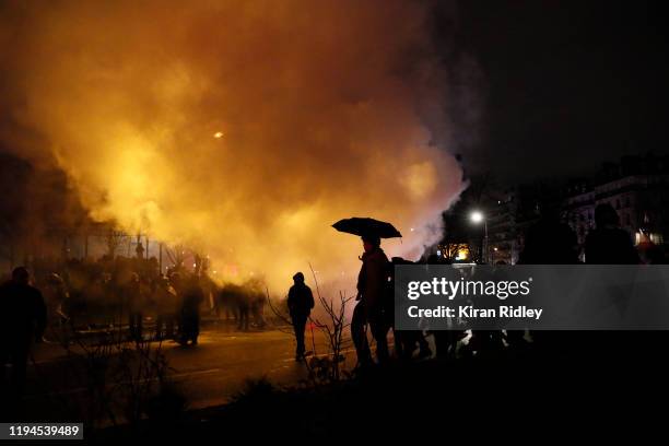 Protestors stand in clouds of tear gas at Place de la Nation as thousands take to the streets of Paris in support of the National Strike on a crucial...