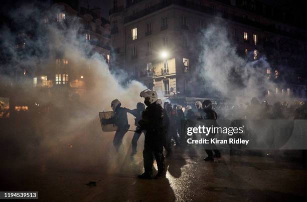 French Riot Police retreat through clouds of tear gas at Place de la Nation as thousands take to the streets of Paris in support of the National...
