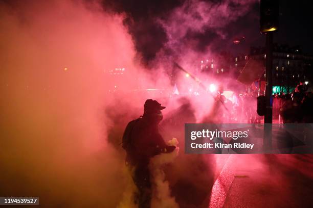 Protestors through tear gas shells back towards French Riot Police at Place de la Nation as thousands take to the streets of Paris in support of the...