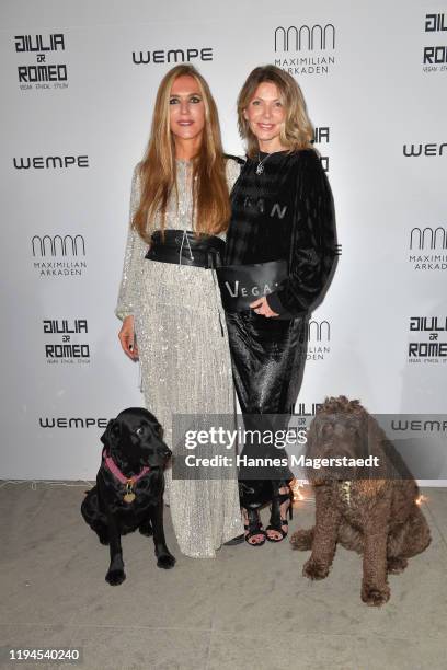 Daniela Brunner with her dog Greta and actress Ursula Karven with her dog Marley attend the Giulia & Romeo Christmas Soiree at Maximilian Arkaden on...