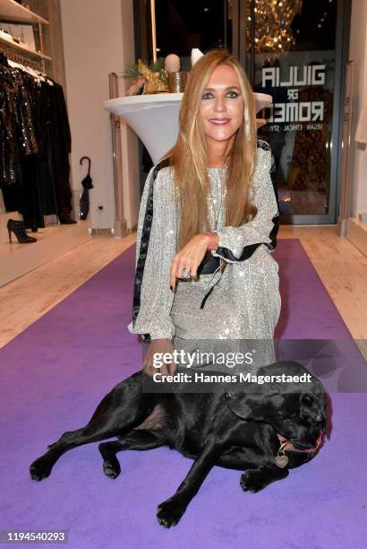 Daniela Brunner with her dog Greta attends the Giulia & Romeo Christmas Soiree at Maximilian Arkaden on December 17, 2019 in Munich, Germany.