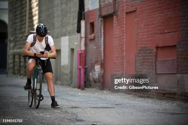 downtown bicycle messenger - downtown calgary stock pictures, royalty-free photos & images