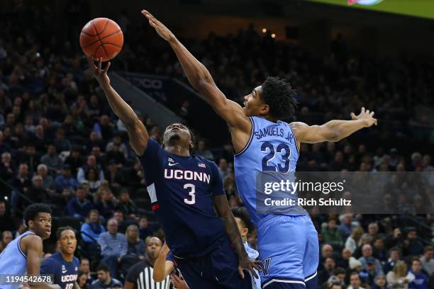 Alterique Gilbert of the Connecticut Huskies attempts a layup against Jermaine Samuels of the Villanova Wildcats during the first half of a college...