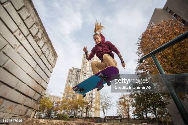 skater woman jumping on her skate. - skating stock pictures, royalty-free photos & images