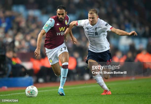 Ahmed El Mohamady of Aston Villa battles for possession with Herbie Kane of Liverpool during the Carabao Cup Quarter Final match between Aston Villa...