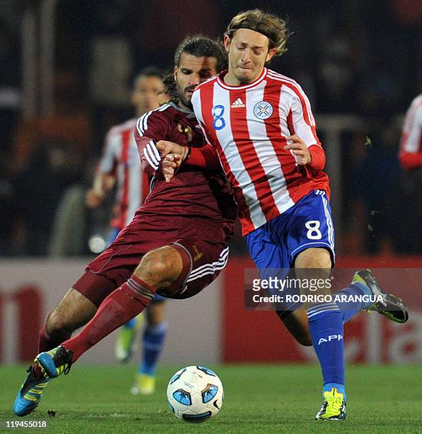 Paraguayan midfielder Edgar Barreto fights for the ball with Venezuelan defender Oswaldo Vizcarrondo, during the 2011 Copa America semi-final...