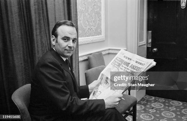 Australian media mogul Rupert Murdoch holding a copy of his News Of The World newspaper during a press conference in London, 25th October 1968.