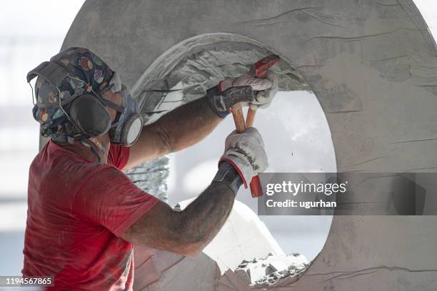a sculptor is sculpting a marble statue. - stone sculptor stock pictures, royalty-free photos & images