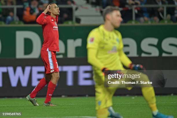 Robin Quaison of Mainz celebrates scoring his teams first goal against goalkeeper Jiri Pavlenka during the Bundesliga match between SV Werder Bremen...