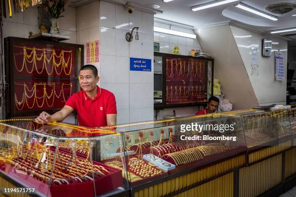 Employees wait for customers at a jewelry store in Yangon, Mayanmar, on Saturday, Jan. 18, 2020. China and neighboring Myanmar agreed to expedite...