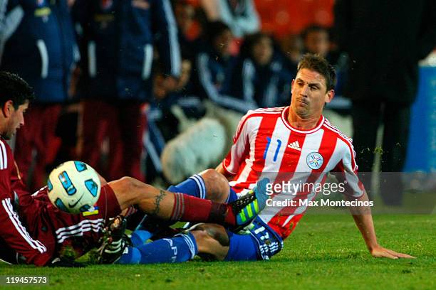Jonathan Santana from Paraguay fights for the ball against Franklin Lucena from Venezuela during a semi final match between Paraguay and Venezuela at...