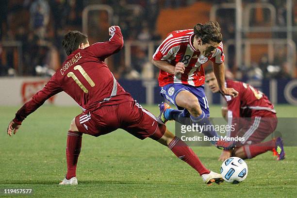 Edgar Barreto of Paraguay struggles for the ball with Cesar Gonzalez of Venezuela during a match as part of Copa America 2011 Semifinal at Malvinas...