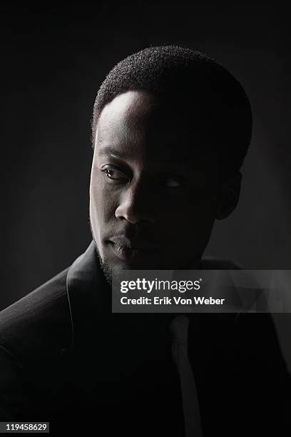 portrait of adult on black background - clave baja fotografías e imágenes de stock