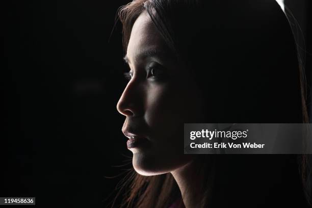 portrait of adult on black background - penumbra fotografías e imágenes de stock