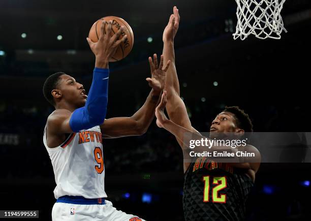 Barrett of the New York Knicks drives toward the basket past De'Andre Hunter of the Atlanta Hawks during the second half of their game at Madison...