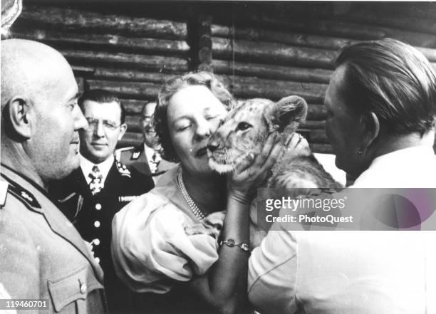 Nazi leader Hermann Goering and his wife, actress Emmy Goring show off their pet lion cub to Italian fascist dictator Benito Mussolini at the...