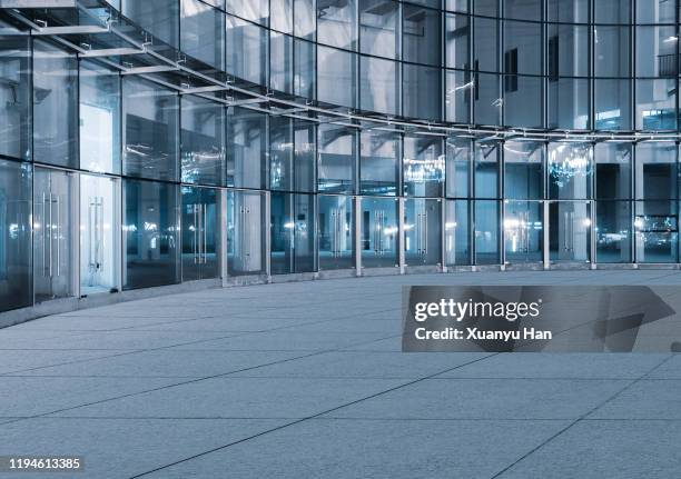 open space in front of modern skyscrapers - office building entrance night stock pictures, royalty-free photos & images