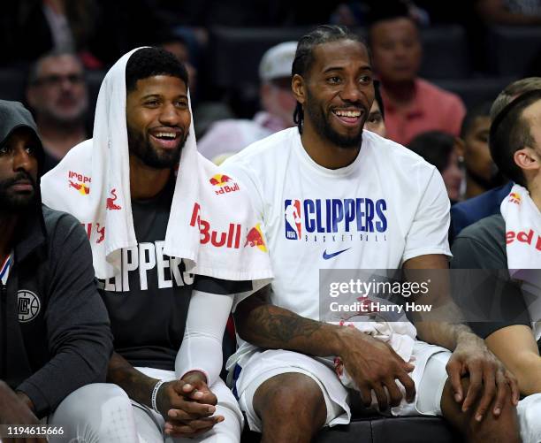 Paul George and Kawhi Leonard of the LA Clippers laugh on the bench during a 120-99 win over the Phoenix Suns at Staples Center on December 17, 2019...