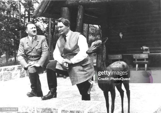 Portrait of Nazi dictator Adolf Hitler and Hermann Goering as they pose next to a deer sculpture on the porch of the latter's villa, Carinhall,...