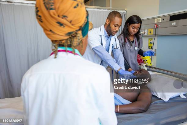 heart attack victim being given resuscitation chest compression - black man heart attack stock pictures, royalty-free photos & images