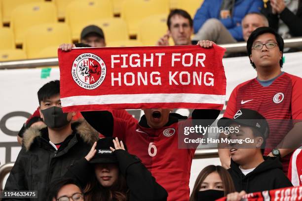 Hong Kong supporters surrounded by security guards during the EAFF E-1 Football Championship match between Hong Kong and China at Busan Asiad Main...