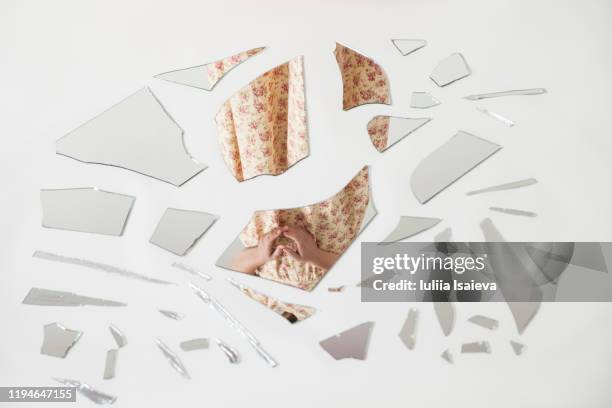 unrecognizable woman reflecting in splintered mirror - shattered glass fotografías e imágenes de stock