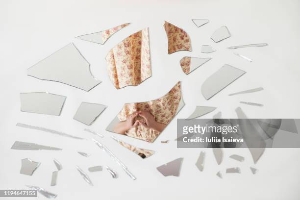 unrecognizable woman reflecting in splintered mirror - broken glass pieces stock pictures, royalty-free photos & images