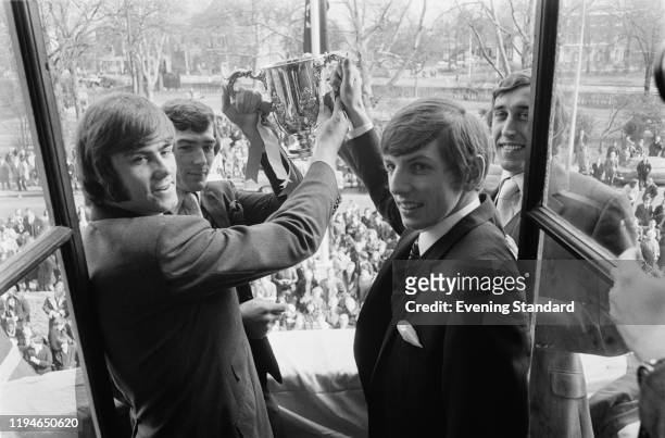 Spurs players, from left, Peter Collins, Pat Jennings, Martin Peters and Martin Chivers stand together on a balcony holding the English football...