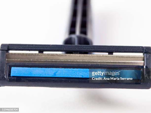 close up of disposable blue razor on a white background - straight razor stock pictures, royalty-free photos & images
