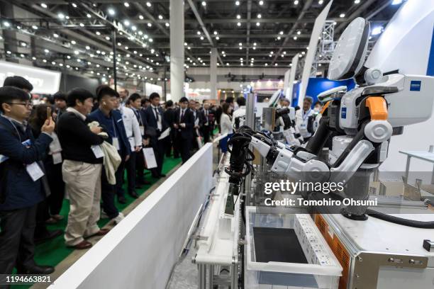 Nextage industrial robots are demonstrated in the Kawada Robotics Corp. Booth at the International Robot Exhibition on December 18, 2019 in Tokyo,...