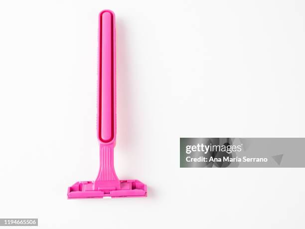 disposable pink razor on a white background - scheermes stockfoto's en -beelden