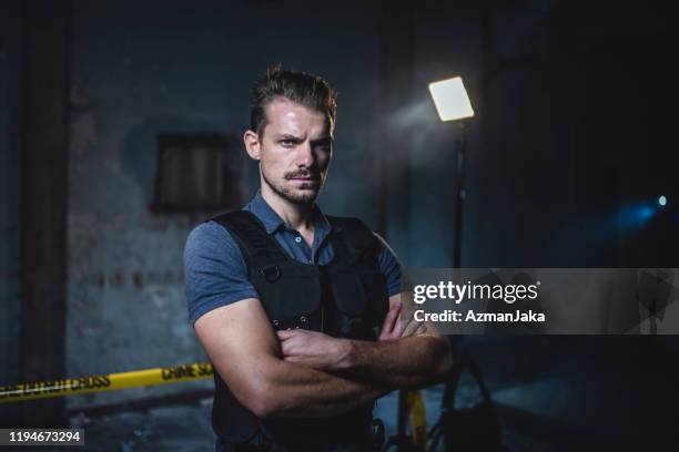 portrait of male police officer at urban crime scene - bulletproof vest old stock pictures, royalty-free photos & images