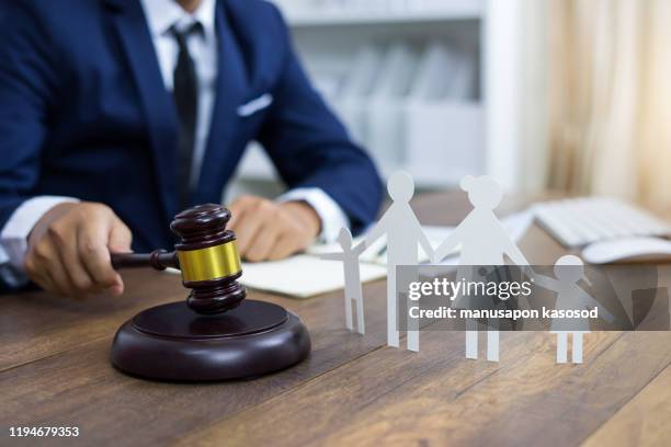 family figure and gavel on table. family law concept - family law stockfoto's en -beelden