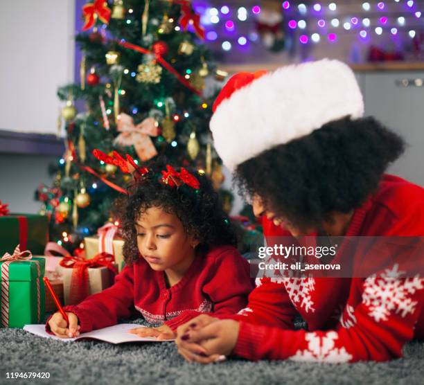 letter to santa - child writing letter to santa stock pictures, royalty-free photos & images