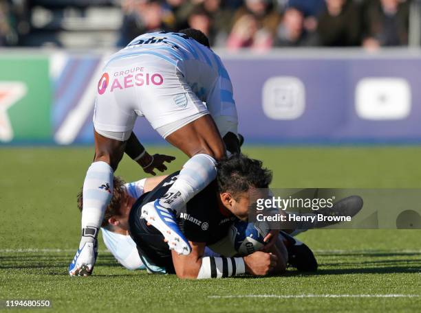 Billy Vunipola of Saracens injures his arm as he is tackled by Virimi Vakatawa and Teddy Iribaren of Racing 92 during the Heineken Champions Cup...