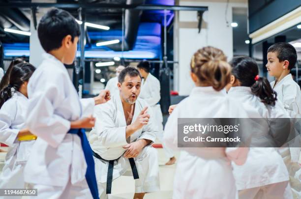 children teaching karate in nursery school. - martial arts kid stock pictures, royalty-free photos & images