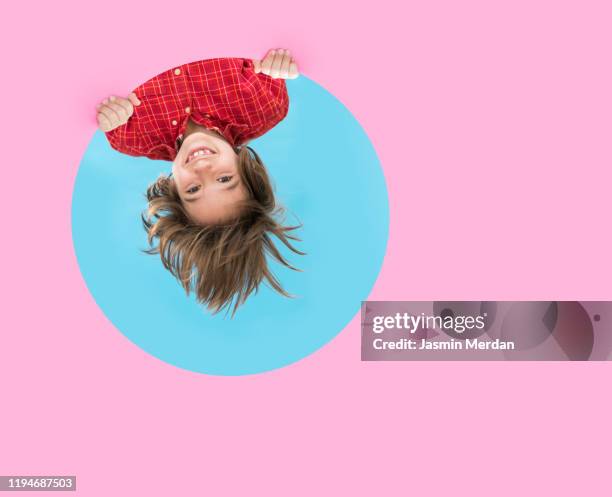 upside down child through pink blue circle - the boy with pink hair stock pictures, royalty-free photos & images